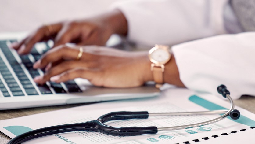 Image of provider sitting at desk typing